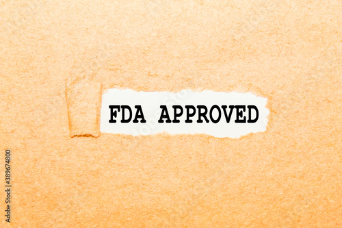 text FDA APPROVED on a torn piece of paper, business concept