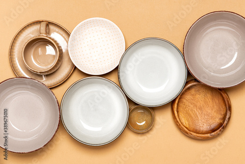 Fotografi Many different ceramic dishes on a beige background top view