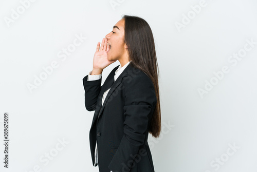 Young asian bussines woman isolated on white background shouting and holding palm near opened mouth.