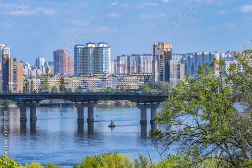 View of Dnieper River with Paton Bridge and architecture of Left Bank of Dnieper in Kyiv. Kyiv, Ukraine.