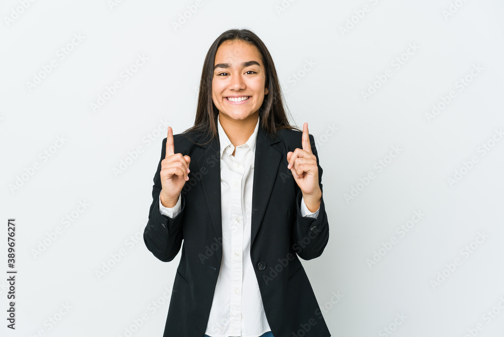 Young asian bussines woman isolated on white background indicates with both fore fingers up showing a blank space. Young asian bussines woman isolated on white background indicates with both fore fingers up showing a blank space.
