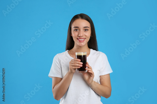 Beautiful woman with cold kvass on blue background. Traditional Russian summer drink