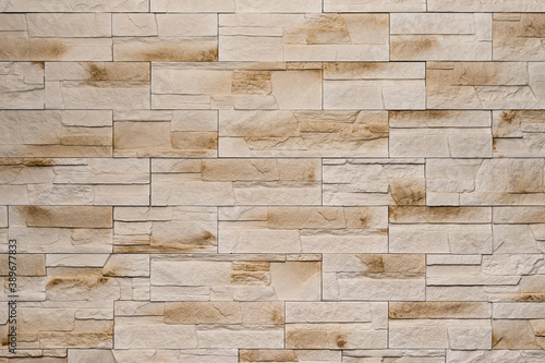 A Wall Made of Light Beige Decorative Stones. Wall Decor. Interior Home Design