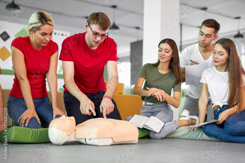 caucasian people practice an exercise of resuscitation during lesson, help injured people, first aid and medicine concept photo