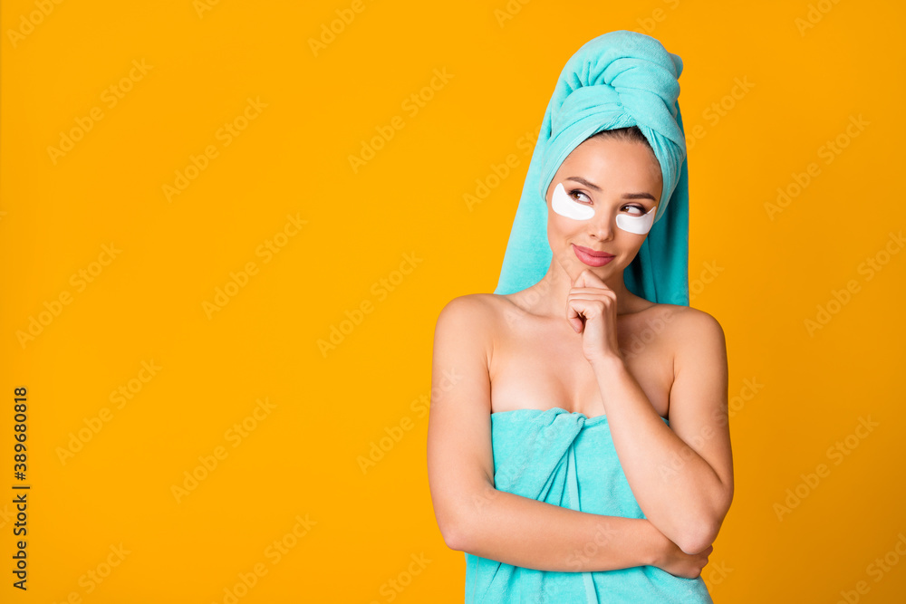 Portrait of attractive thoughtful lady arm on chin look empty space turquoise towel isolated on yellow color background Portrait of attractive thoughtful lady arm on chin look empty space turquoise towel isolated on yellow color background