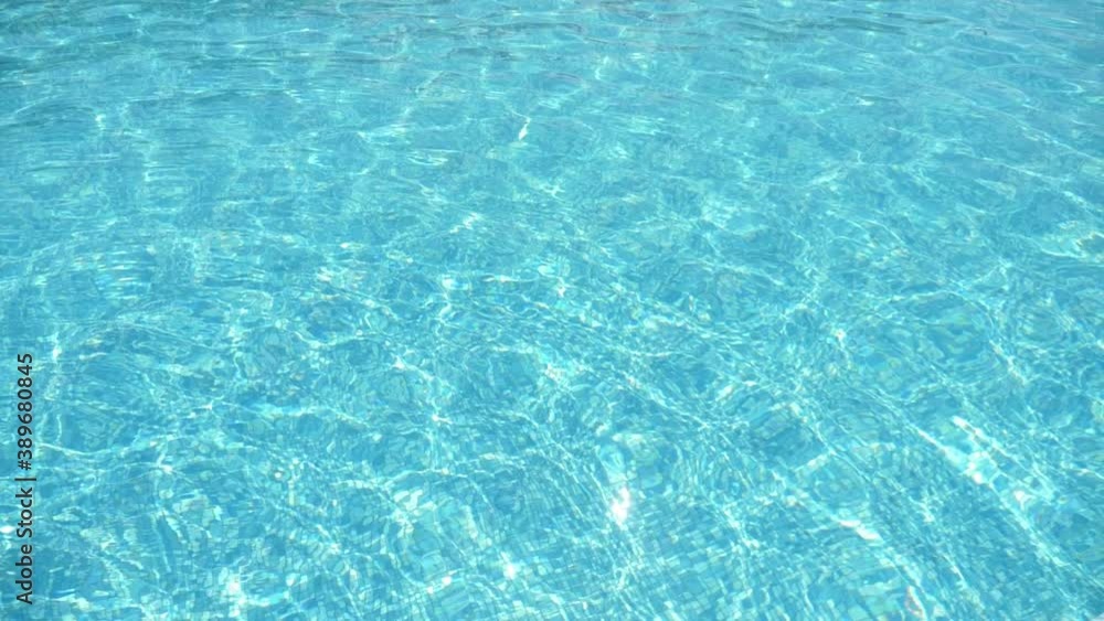 Shiny waves coming up and down in a wading pool on sunny day in summer Shiny waves coming up and down in a wading pool on sunny day in summer