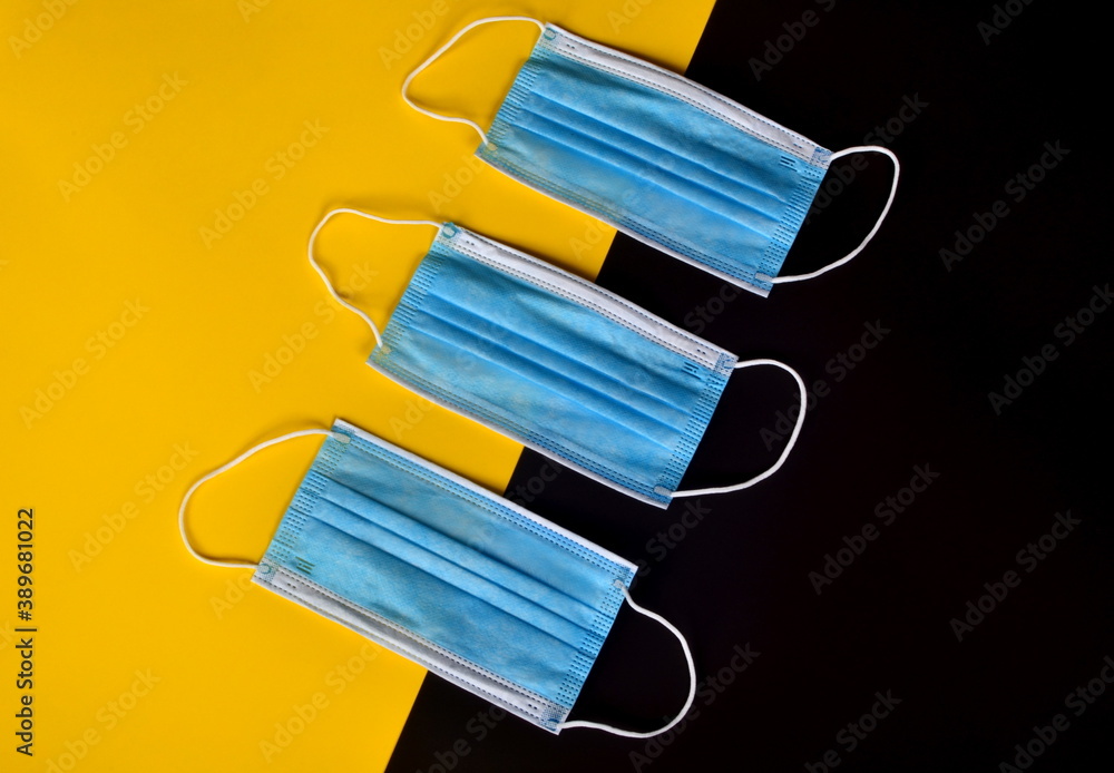 Medical face masks on a yellow black background. Coronavirus covid - 19 Concept Medical face masks on a yellow black background. Coronavirus covid - 19 Concept