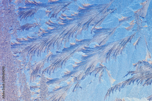 Frost forms in patterns on window glass on a cold winter morning