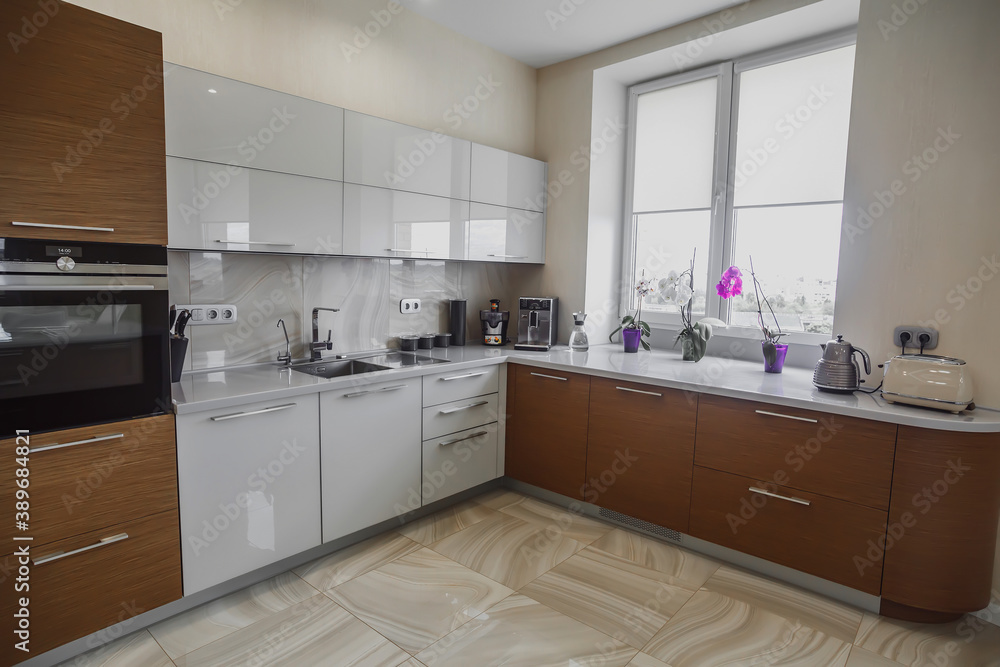 View of luxury modern fitted kitchen with stainless steel appliances View of luxury modern fitted kitchen with stainless steel appliances