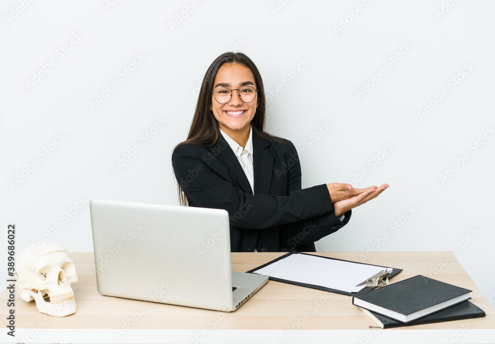 Young traumatologist asian woman isolated on white background holding a copy space on a palm. Young traumatologist asian woman isolated on white background holding a copy space on a palm.