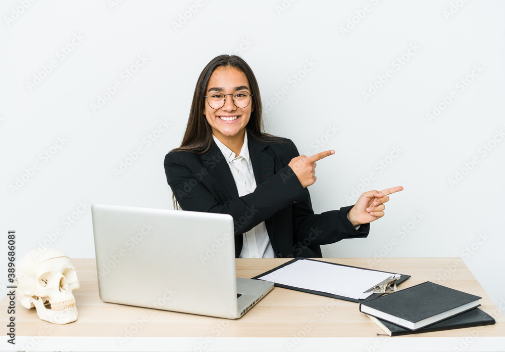 Young traumatologist asian woman isolated on white background excited pointing with forefingers away. Young traumatologist asian woman isolated on white background excited pointing with forefingers away.