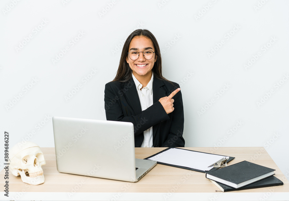 Young traumatologist asian woman isolated on white background smiling and pointing aside, showing something at blank space. Young traumatologist asian woman isolated on white background smiling and pointing aside, showing something at blank space.