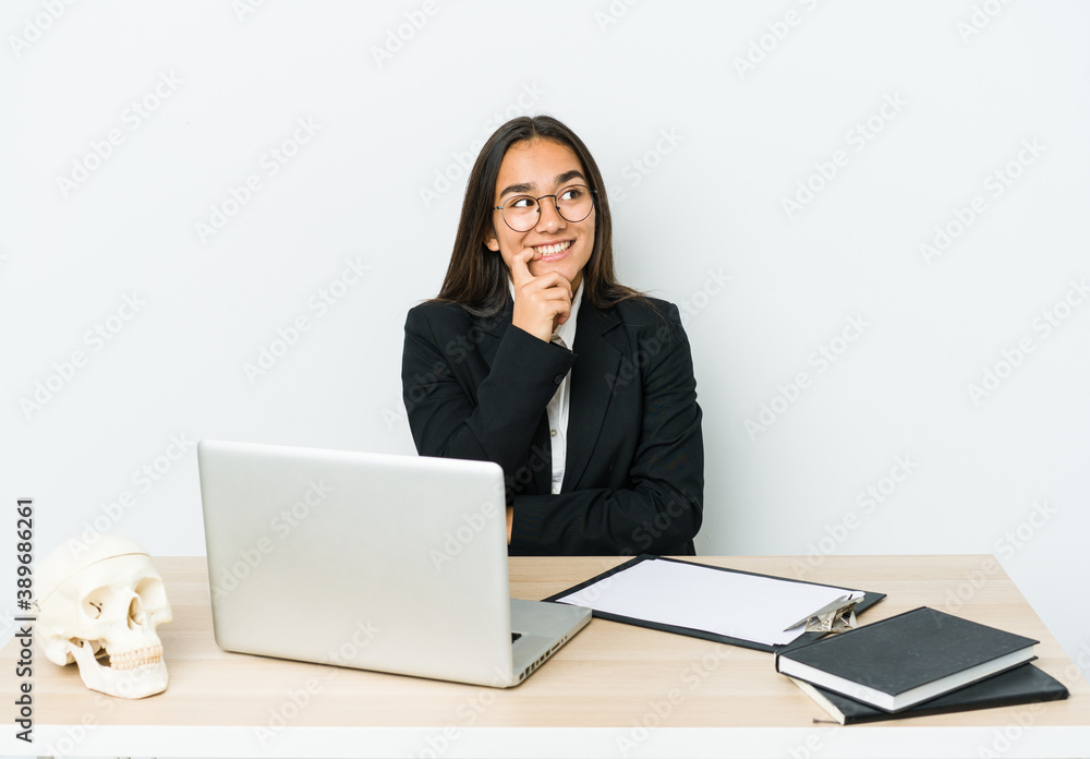 Young traumatologist asian woman isolated on white background relaxed thinking about something looking at a copy space. Young traumatologist asian woman isolated on white background relaxed thinking about something looking at a copy space.