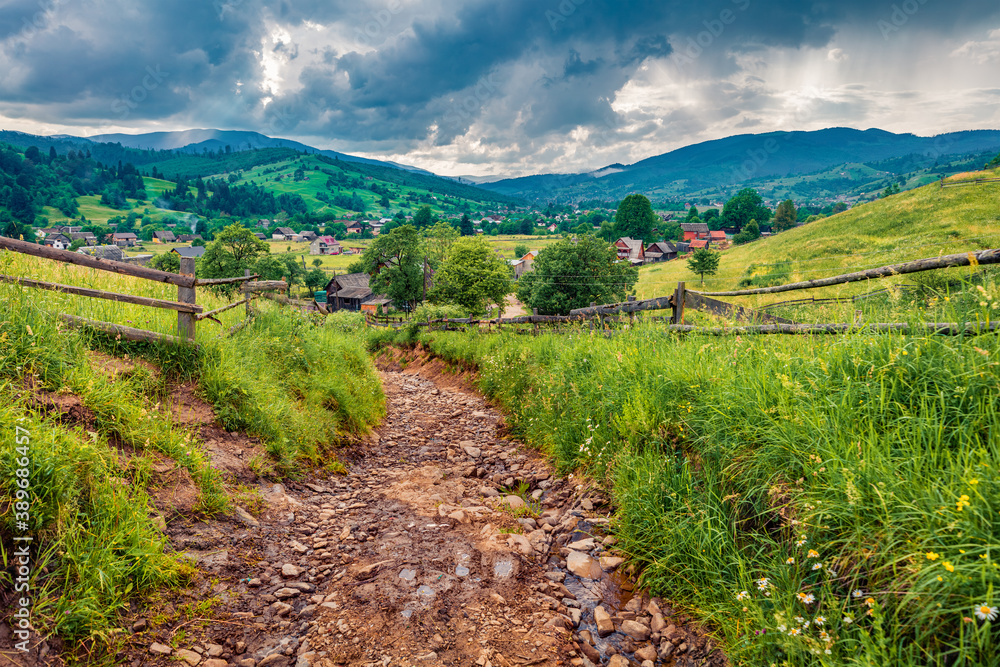 Captivating summer scene of Yasinya village with old country road, Ukraine, Europe. Fresh green view of Carpathians. Picturesque morning scene of contryside. Traveling concept background.