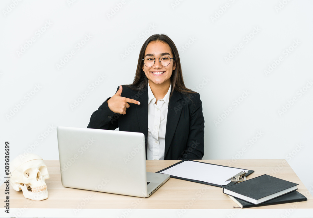 Young traumatologist asian woman isolated on white background person pointing by hand to a shirt copy space, proud and confident Young traumatologist asian woman isolated on white background person pointing by hand to a shirt copy space, proud and confident