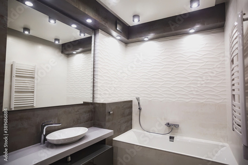 Modern bathroom in white and gray tones with mosaic on wide angle view