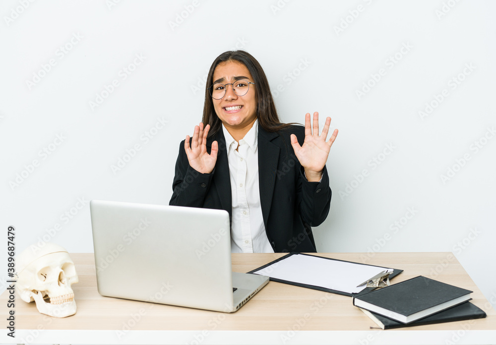 Young traumatologist asian woman isolated on white background rejecting someone showing a gesture of disgust. Young traumatologist asian woman isolated on white background rejecting someone showing a gesture of disgust.