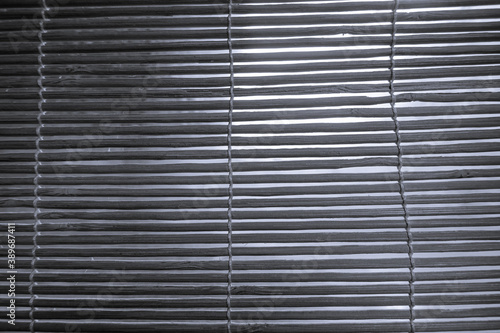 Black and white photo of rattan blinds. Wooden curtain background and texture