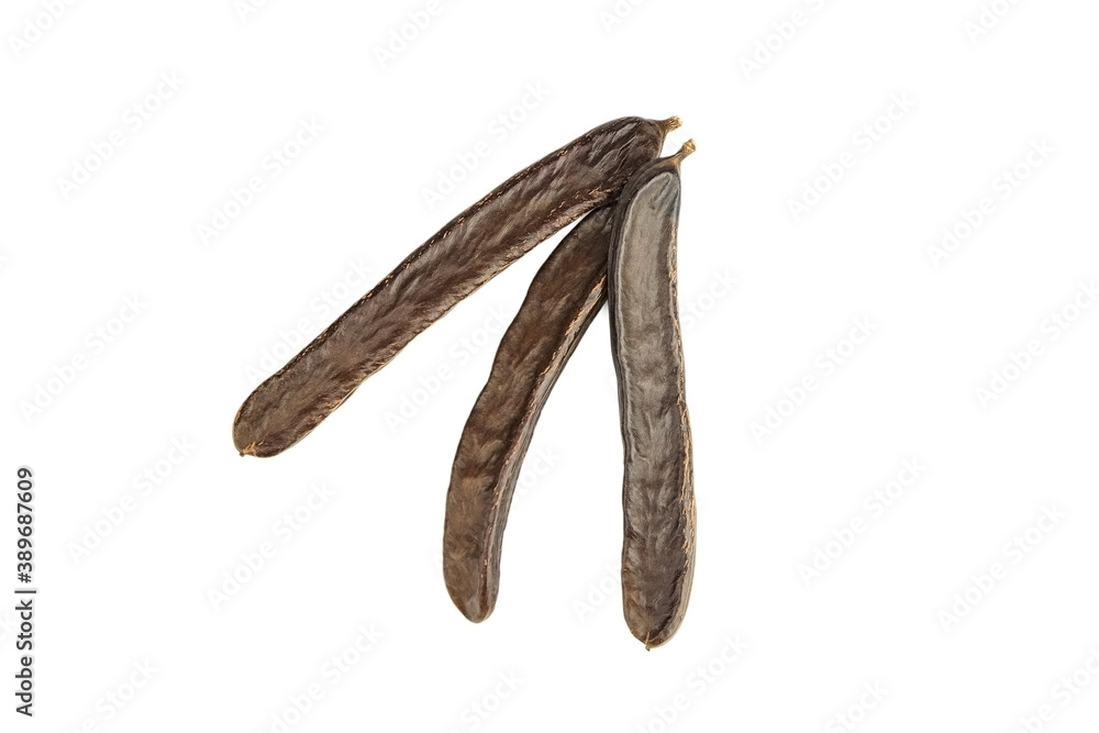 Three dry carob pods isolated on white background. Three dry carob pods isolated on white background.