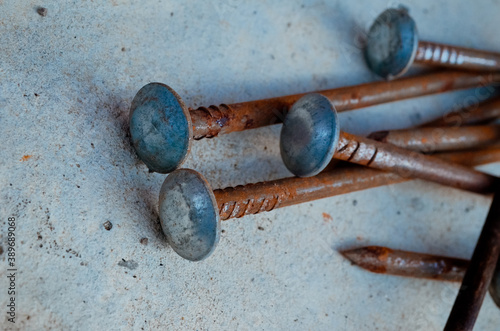 long metal nails on a concrete surface