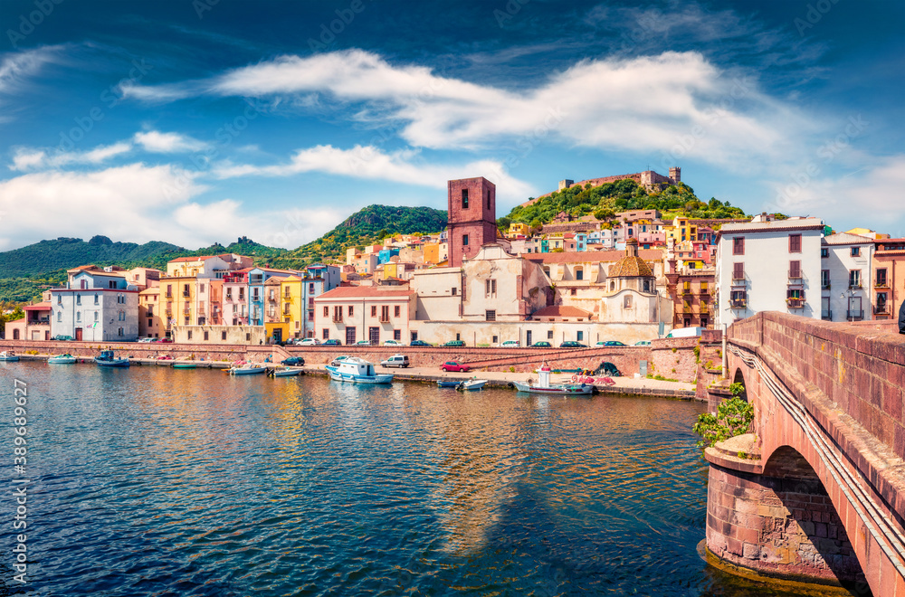 Impressive summer cityscape of Bosa town with Ponte Vecchio bridge across the Temo river. Marvelous morning view of Sardinia island, Italy, Europe. Traveling concept background.