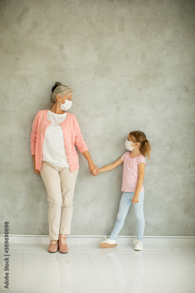 Grandmother and granddaughter wearing a respiratory masks Grandmother and granddaughter wearing a respiratory masks