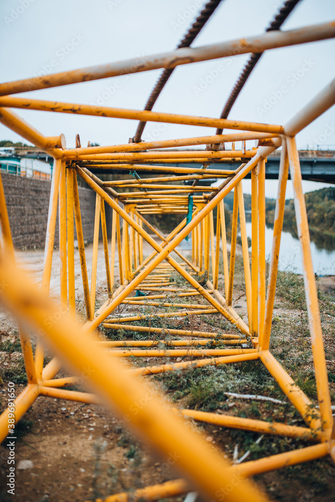Perspective view through the entire length of the tower crane boom - metal welded structure in yellow color Perspective view through the entire length of the tower crane boom - metal welded structure in yellow color