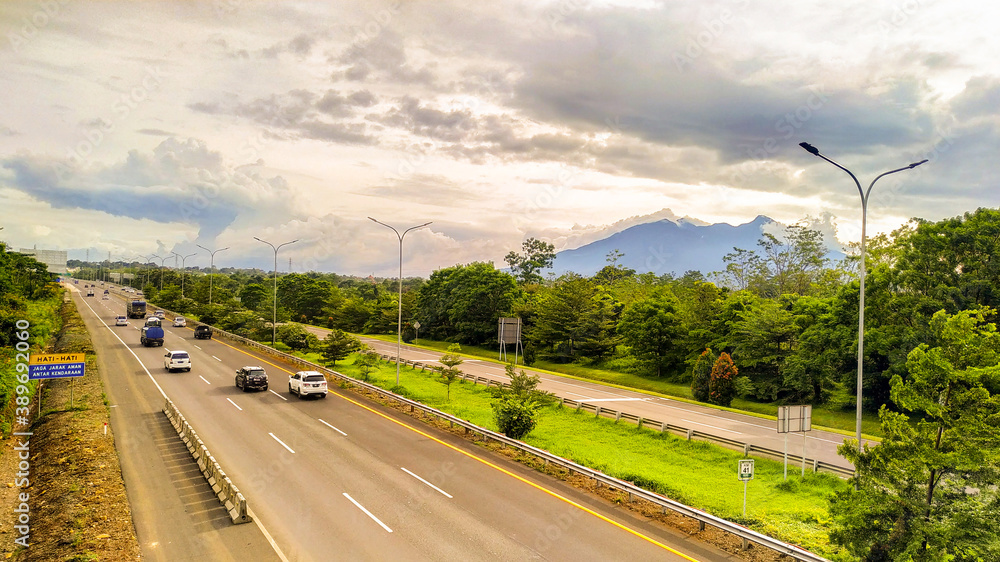 Mount Pangrango can be seen from the bridge over the Ciawi highway in Bogor Raya housing Mount Pangrango can be seen from the bridge over the Ciawi highway in Bogor Raya housing