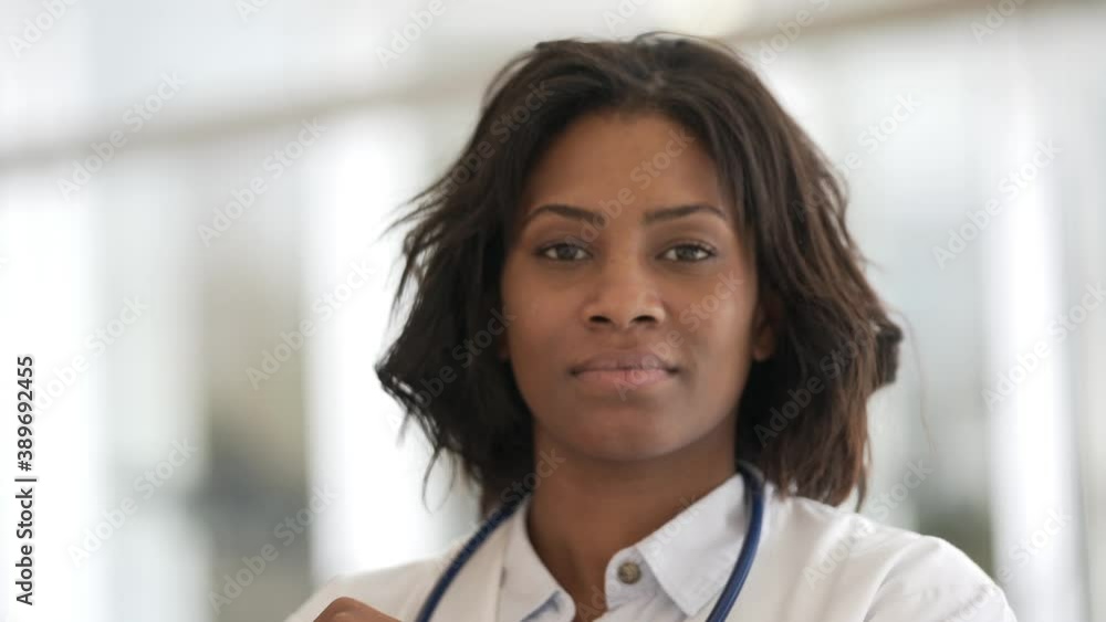 Smiling woman doctor standing in hospital hallway Smiling woman doctor standing in hospital hallway