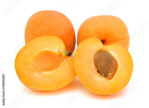 fresh yellow plums and a cut one on a white background