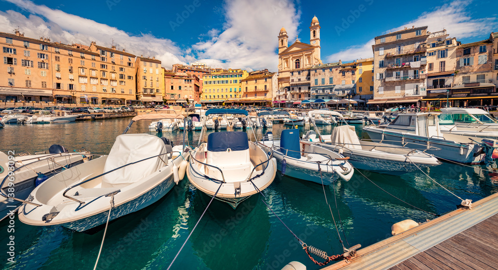 Attractive summer cityscape of Bastia port with twin-towered Church of St. Jean-Baptiste rising behind it. Splendid morning view of Corsica island, France, Europe. Beautiful Mediterranean seascape.