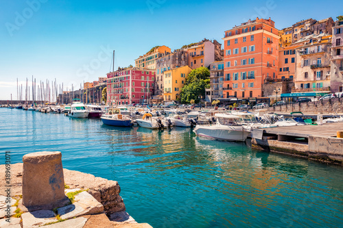 Colorful houses on the shore of Bastia port. Bright morning view of Corsica island, France, Europe. Magnificent Mediterranean seascape with yacht. Traveling concept background. photo