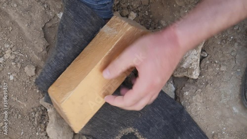 Close-up of finding a buried bar of gold treasure.