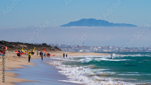 Image of Valdevaqueros Beach in Tarifa with the mountains of Africa covered by clouds