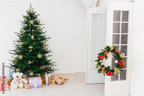Christmas tree pine with gifts for the new year of the white room 2021 2022