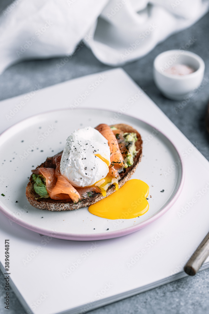 Fresh sandwich with smoked salmon poached egg and avocado 