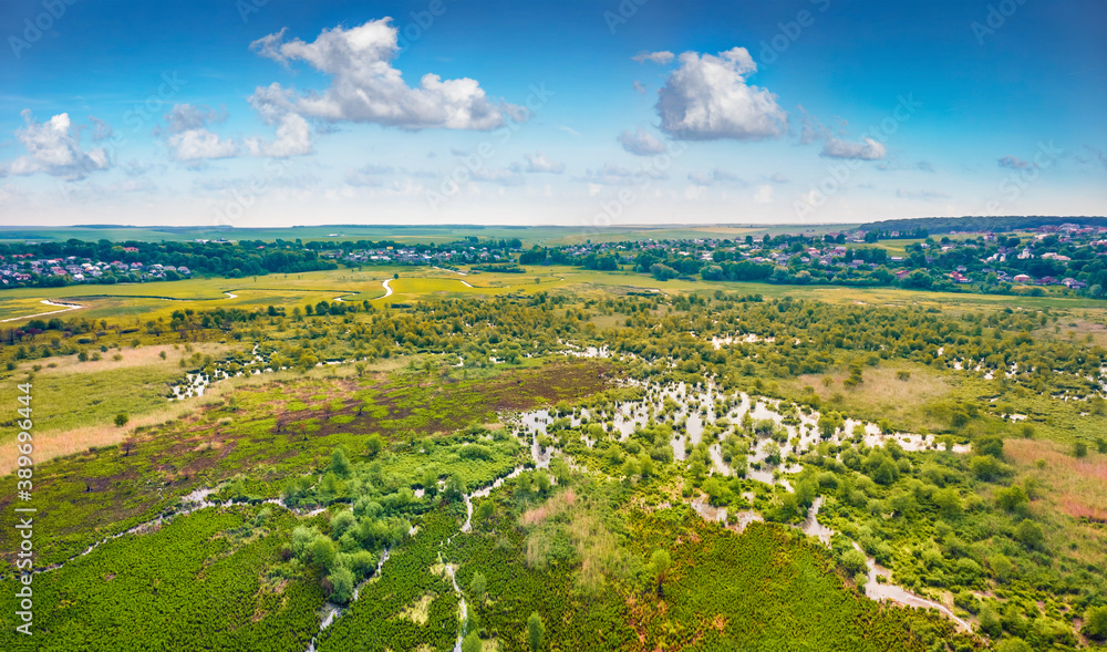 Aerial summer view of flooded valley. Picturesque landscape of snake shape Seret river. Fresh green scene of Ternopil countryside, Ukraine. View from flying drone. Traveling concept background..