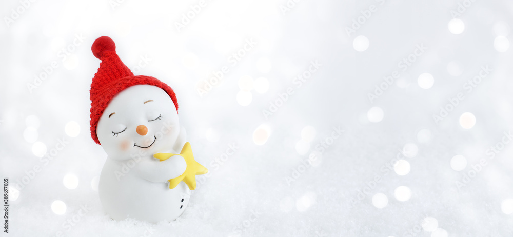 Christmas background. Happy snowman standing in winter christmas landscape. Merry christmas and happy new year greeting card. Funny snowman in hat on snowy background. Banner. Copy space