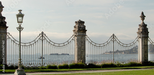 Beautiful wrought-iron park fence and a view of the Bosphorus through the lattice of the fence