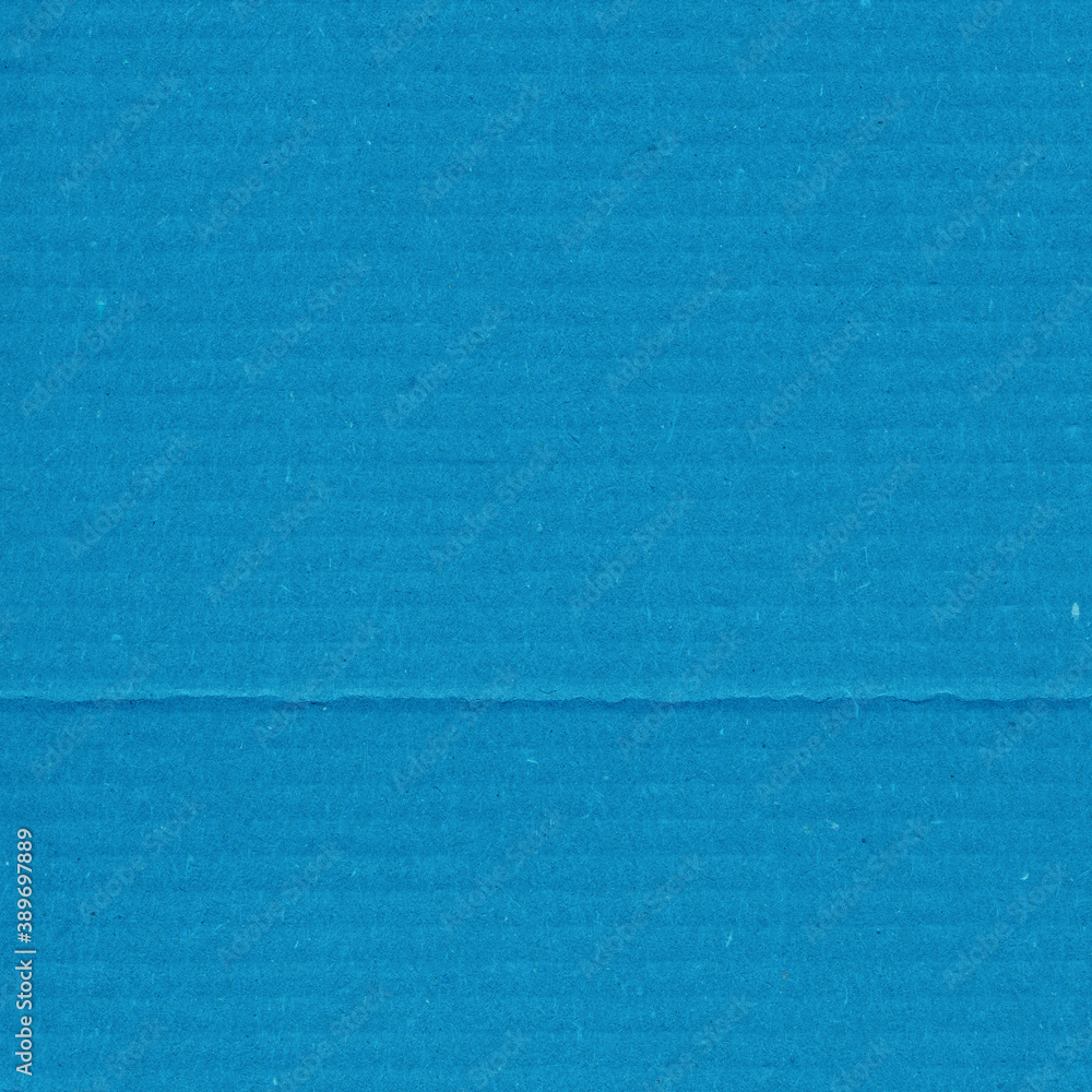 Obraz premium A blue vintage rough sheet of carton. Recycled environmentally friendly cardboard paper texture. Simple minimalist papercraft background.