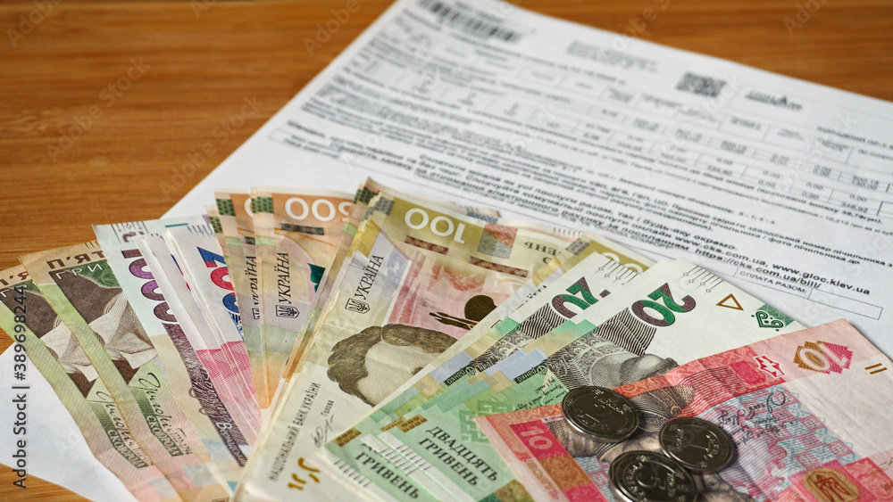 Ukrainian money hryvnia and coins penny wooden background, utility bill. Ukrainian money hryvnia and coins penny wooden background, utility bill.