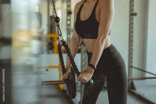 A women working out training arms in gym gaining weight pumping up muscles with dumbbells and on machines fitness concept..Fitness ,workout, gym exercise ,lifestyle and healthy concept.