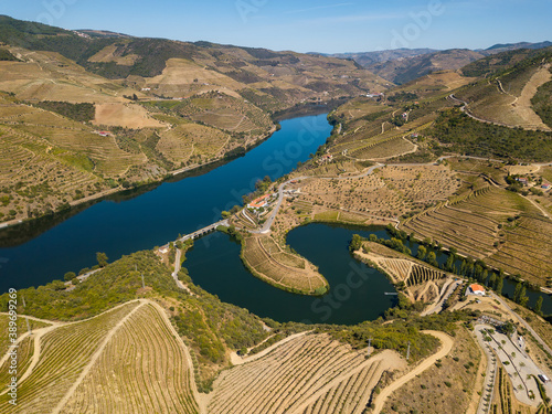 Douro wine valley region, Portugal. Vineyards landscape tourist attraction and travel destination. Drone aerial top view of s shaped bend river.