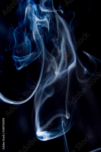 Abstract flowing Blue smoke on dark background wispy