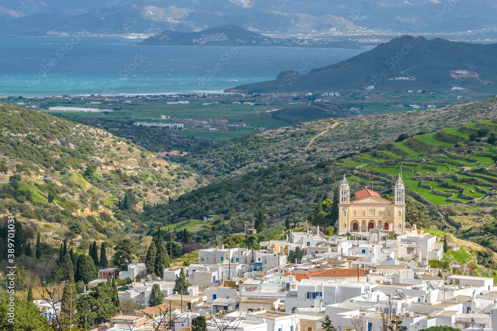 view traditional architecture with Cycladitic whitewashed houses , the cristian church of Agia Triada and naxos island as background  in the traditional village  lefkes Paros island, Greece.