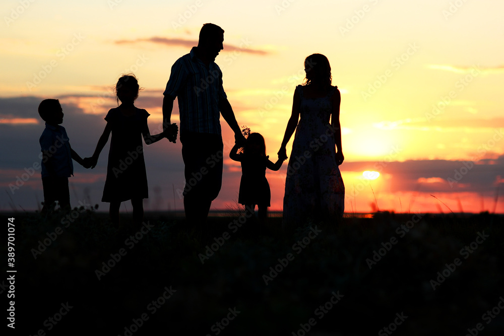 A Happy family silhouette at sea with reflection in park in nature