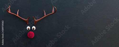 Tableau sur toile Reindeer antlers with red fluffy nose and big eyes, Christmas card template, bla