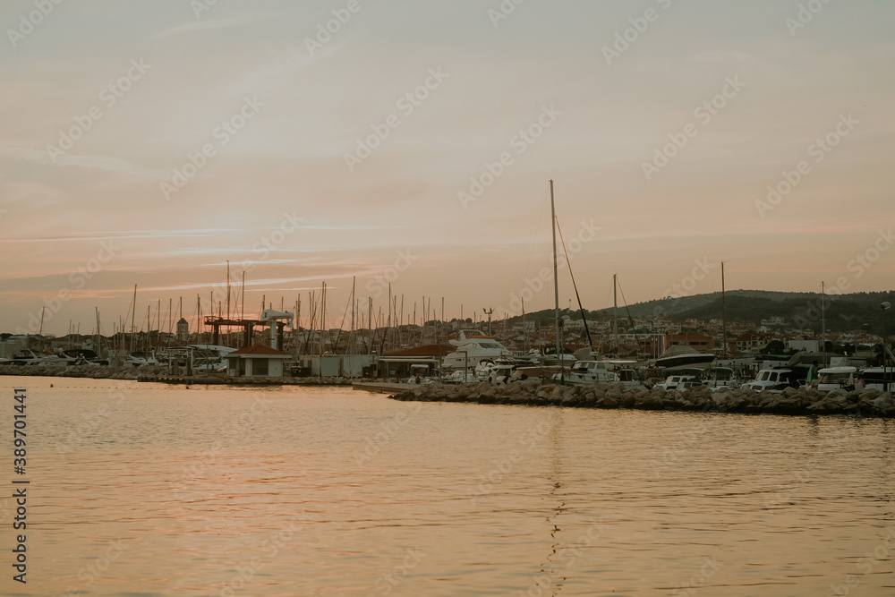There are many yachts, boats and ships at sea. Marina at sunset. Vosice Croatia Gorgeous summer sunset by the ocean