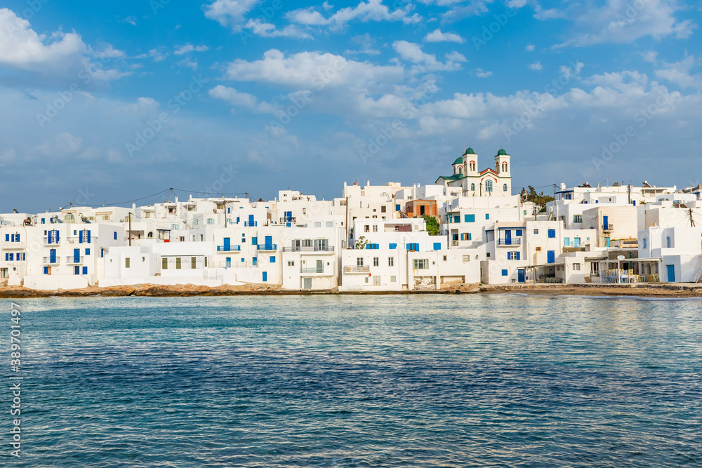 Traditional Cycladitic view of whitewashed houses with the christian church of kimisis Theotokou  in Naousa  Paros island, Greece