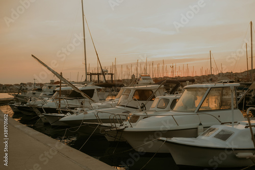 There are many yachts, boats and ships at sea. Marina at sunset.